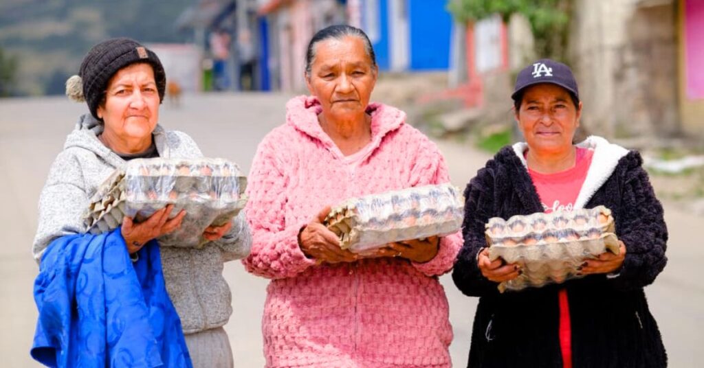Familias vulnerables recibiendo cubetas de huevos del programa Alimentos para la Vida de Prosperidad Social
